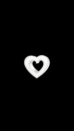 a white heart shaped object on a black background