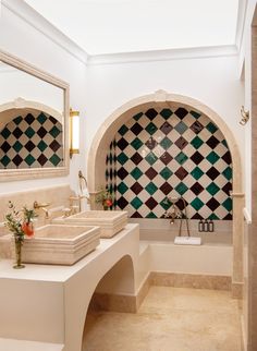 a bathroom with two sinks and tiled walls