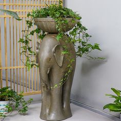 an elephant planter with plants in it