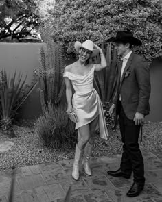 black and white photo of man and woman in cowboy hats standing next to each other