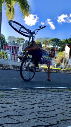 a man riding a bike with a bicycle wheel attached to it