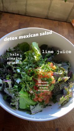 a white bowl filled with salad on top of a wooden table