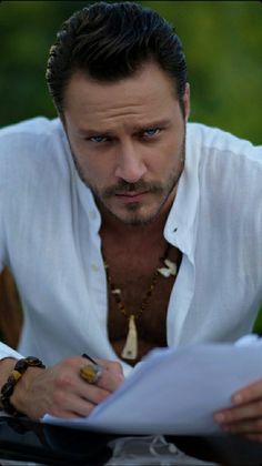 a man in white shirt looking at papers