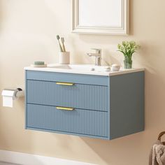 a bathroom vanity with two drawers and a mirror on the wall next to a towel dispenser