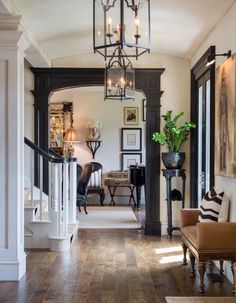 the inside of a house with wood flooring and sliding doors leading to other rooms