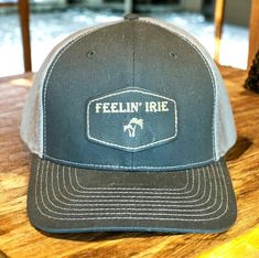 Feelin' Irie Trucker Hat Richardson Hat Color: Black / Graphite Leather Color: Black / Gold 60/40 cotton/polyester 95/5 polyester stretch/spandex mesh back Structured, six-panel, mid-profile Pre-curved contrast stitched visor Comfort stretch R-Flex sweatband Adjustable snapback closure Not recommended for machine wash Fitted Trucker Hat With Flat Brim, Fitted Outdoor Hat With Curved Bill, Fitted Snapback Outdoor Hats, Fitted Trucker Hat With Curved Brim, Fitted Trucker Hat With Curved Bill, Fitted Trucker Baseball Cap With Flat Brim, Fitted Snapback Hat For Outdoor, Fitted Trucker Hat Snapback Style, Fitted Trucker Hat For Outdoor