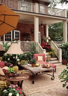 an outdoor living area with patio furniture and flowers