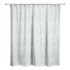 a white shower curtain hanging on the side of a bathtub with an ornate pattern