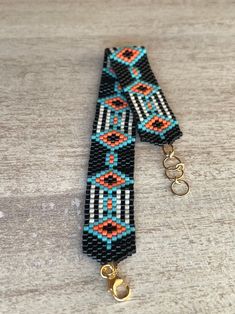 a beaded tie with two rings on it