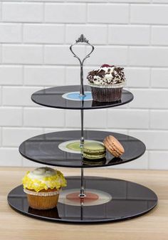 three tiered cake stand with cupcakes on top