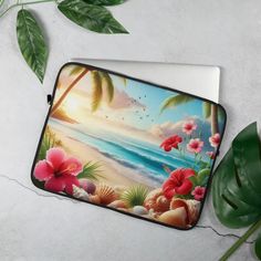 a laptop case with tropical flowers on the beach and palm trees in the background, sitting on a table next to a potted plant