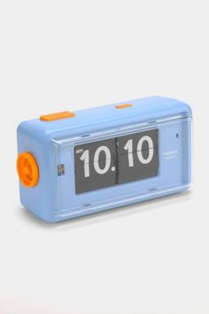 a blue alarm clock with an orange face