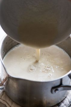 a pot filled with liquid being poured into it