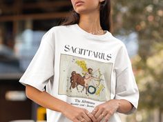 a woman wearing a t - shirt with the zodiac sign sagittrius on it