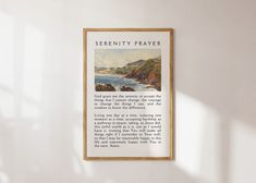 there is a framed poster hanging on the wall next to a window that reads serenity prayer