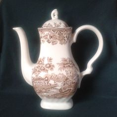 a white tea pot sitting on top of a table