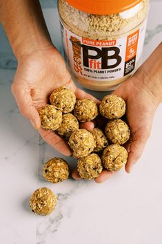 two hands holding peanut butter and oatmeal balls next to a jar of peanut butter