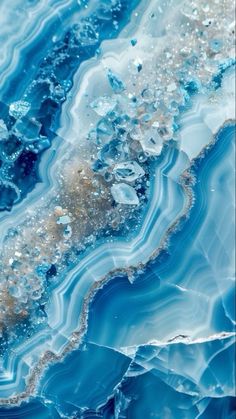 an abstract painting with blue and white waves on it's surface, as well as bubbles