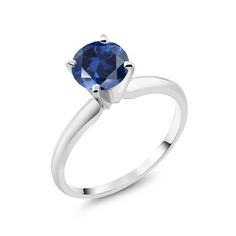 a white gold ring with a blue sapphire stone