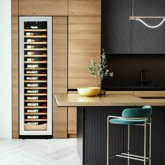 a kitchen with a wine cooler and bar stools