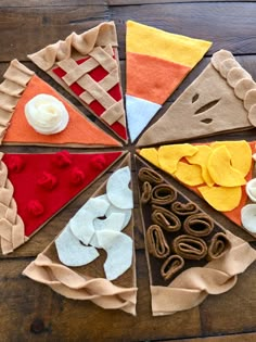 a piece of felt pizza sitting on top of a wooden table