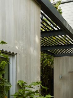 an outside view of a building with plants growing on it