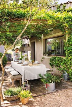 an outdoor dining area with table and chairs