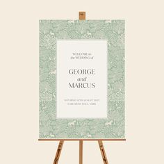 an easel with a wedding card on it and the words george and marcus