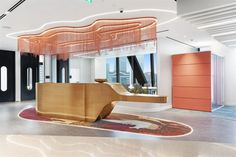 an office lobby with a curved counter and chandelier