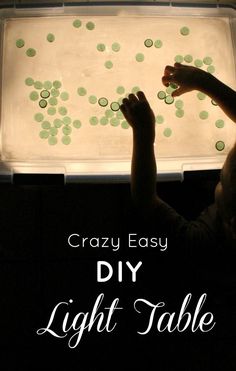 a child is holding up a light table that has green dots on it and the words crazy easy diy light table