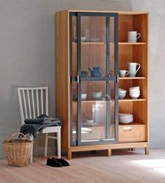 a wooden cabinet sitting next to a white chair