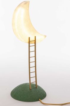 a lamp that is shaped like a ladder with a half moon on the top and side