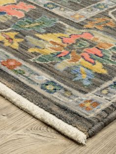 an area rug on the floor with wooden floors and wood planks in the background