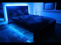 a bed in a room with blue lighting