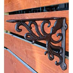 a close up of a wooden bench with metal brackets