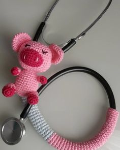 a pink crocheted teddy bear with a stethoscope attached to it