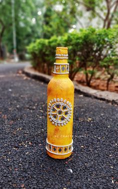 a yellow bottle sitting on the side of a road