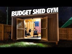 a wooden shed with the words budget shed gym written on it and an american flag