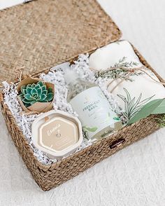 an open wicker basket with various items in it sitting on a white tablecloth