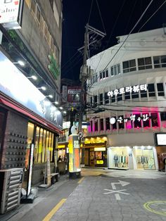 an empty city street at night with neon lights