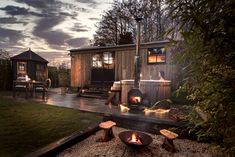 an outdoor hot tub next to a wooden cabin