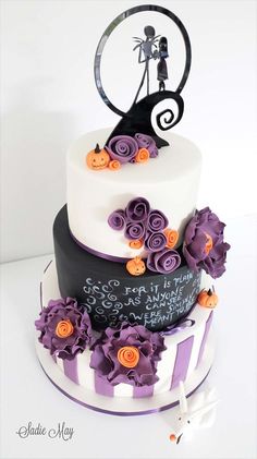 a three tiered cake decorated with purple and orange flowers