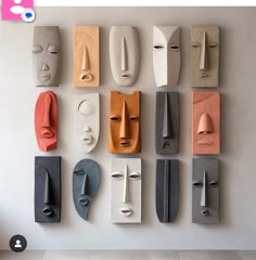 the wall is made up of different shapes and sizes of masks on each one side