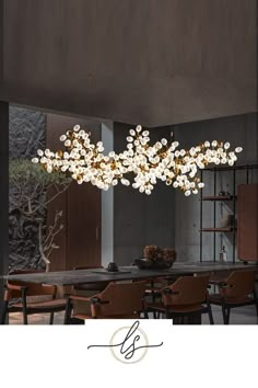 a large chandelier hanging over a dining room table with chairs and a vase on it