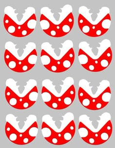 red and white polka dots are arranged in the shape of ovals on a gray background