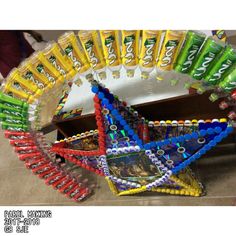 an assortment of colorful toothpaste tubes arranged in the shape of a star on display