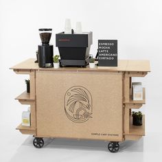 a coffee machine sitting on top of a cart with shelves below it that hold various items