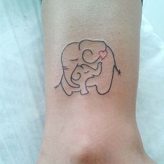 an elephant with a heart tattoo on its foot