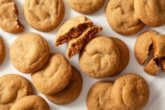 several cookies are cut in half on a white surface