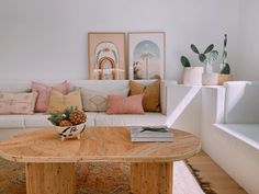 a living room filled with lots of furniture next to a white couch and coffee table